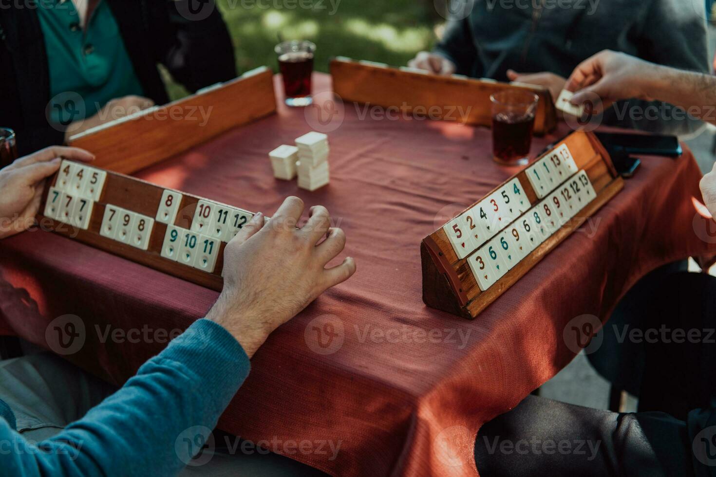 A group of men drink traditional Turkish tea and play a Turkish game called Okey photo