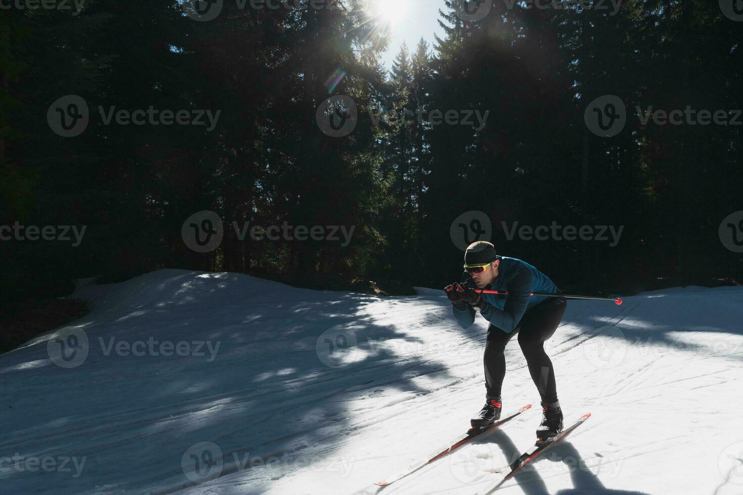 Nordic skiing or Cross-country skiing classic technique practiced by man in a beautiful panoramic trail at morning. photo