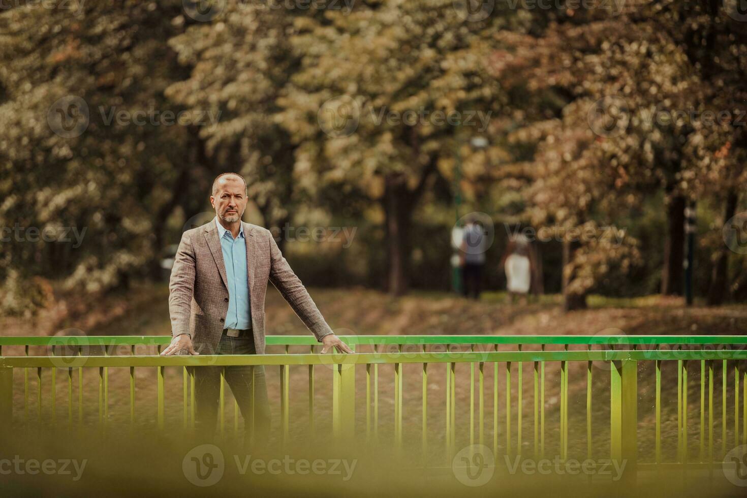 focused businessman in suit walking in urban environment. photo