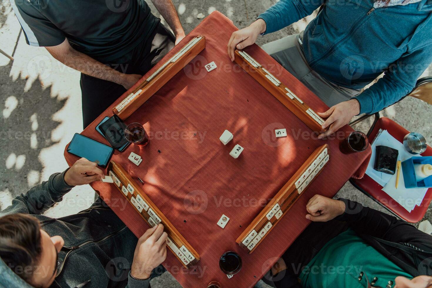 A group of men drink traditional Turkish tea and play a Turkish game called Okey photo