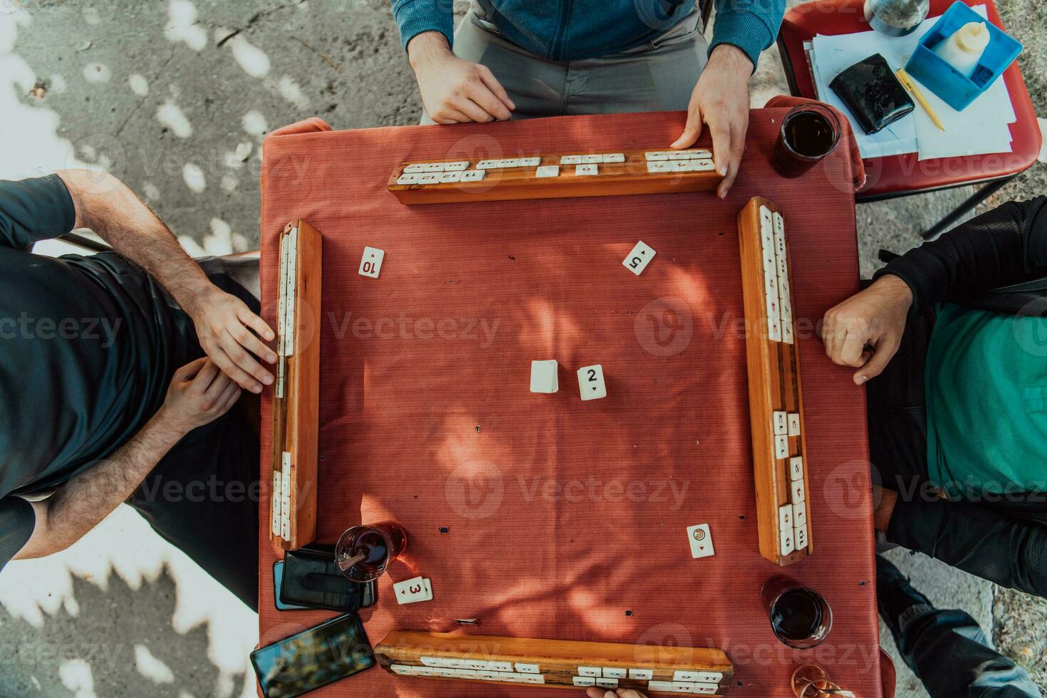 A group of men drink traditional Turkish tea and play a Turkish game called Okey photo