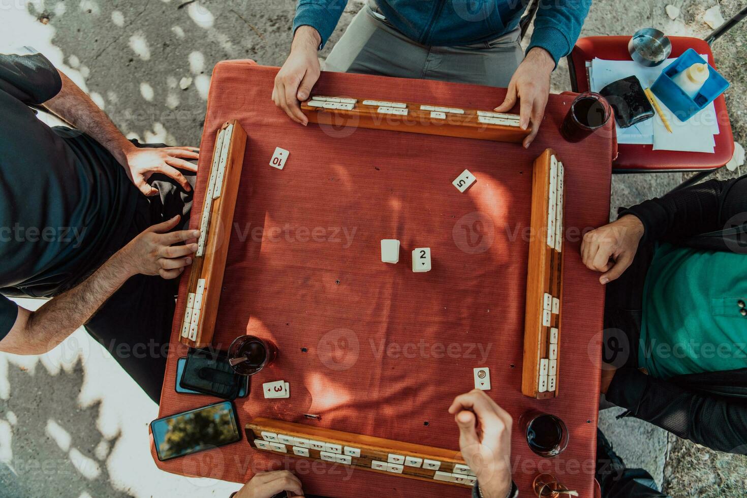 A group of men drink traditional Turkish tea and play a Turkish game called Okey photo