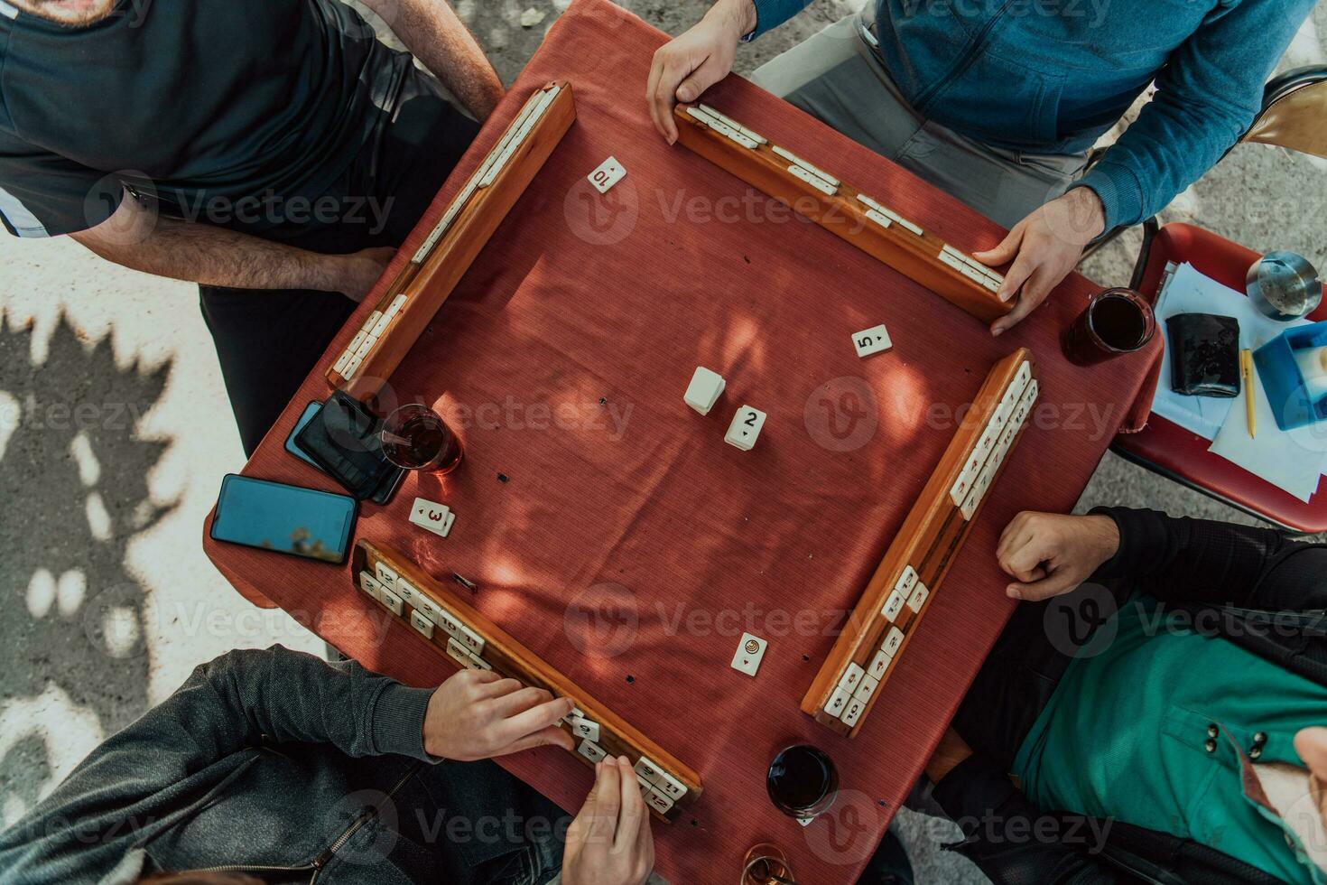 A group of men drink traditional Turkish tea and play a Turkish game called Okey photo