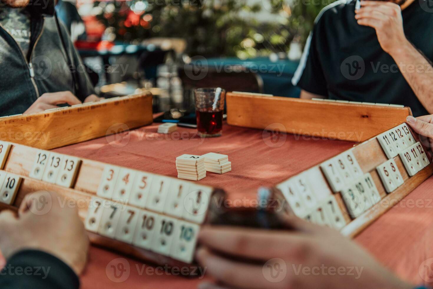 A group of men drink traditional Turkish tea and play a Turkish game called Okey photo