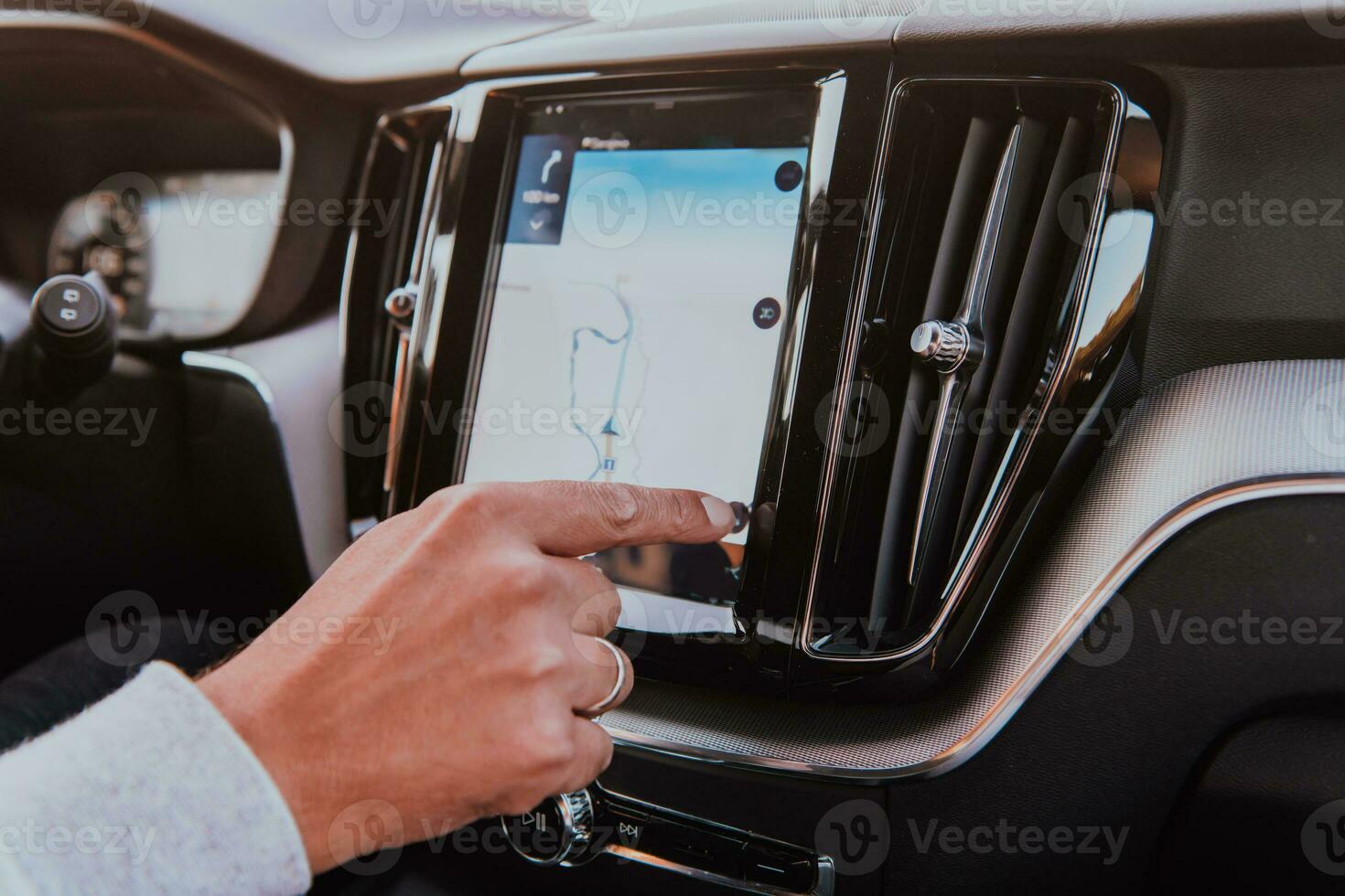 Close-up Of Man Hand Using GPS Navigation Inside Car photo