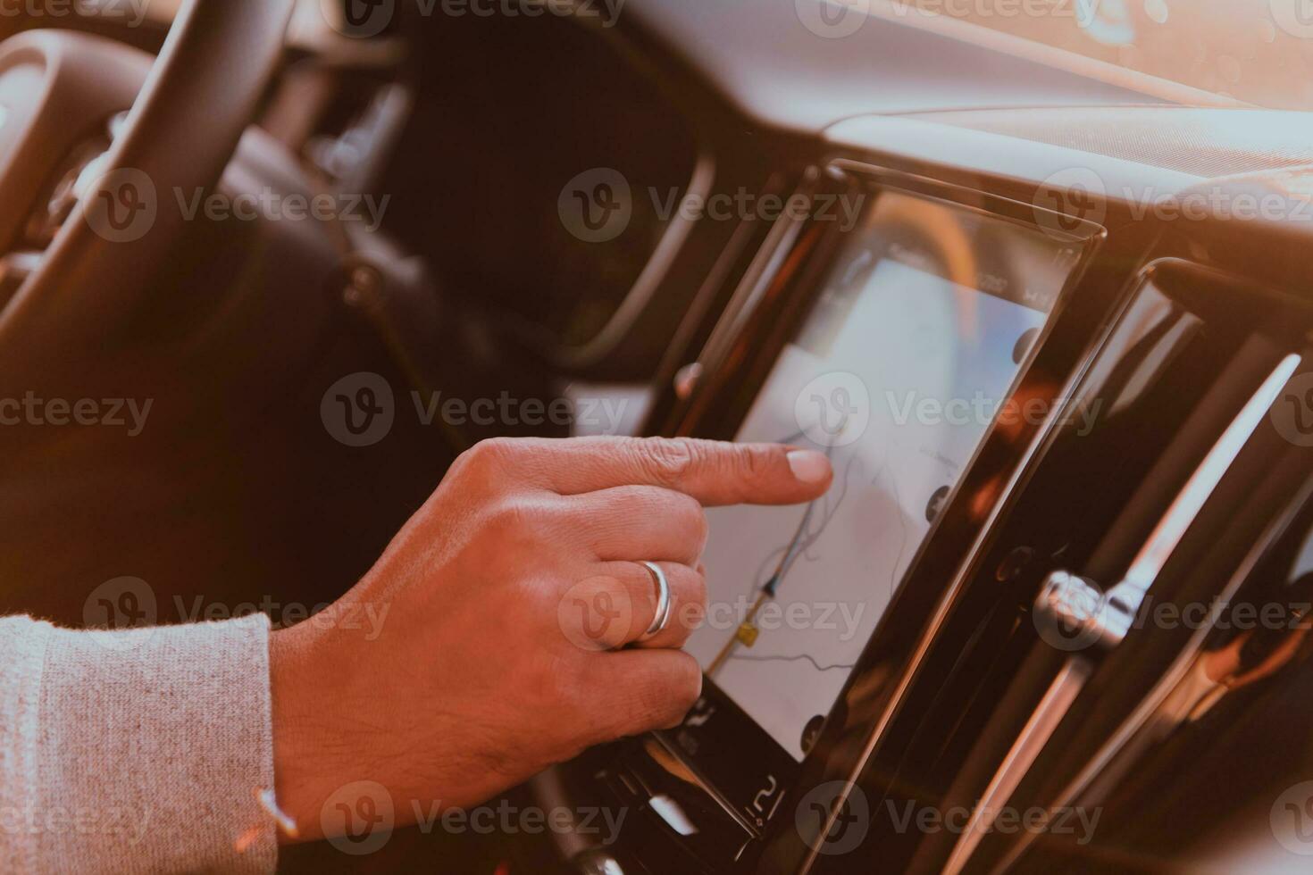 Close-up Of Man Hand Using GPS Navigation Inside Car photo