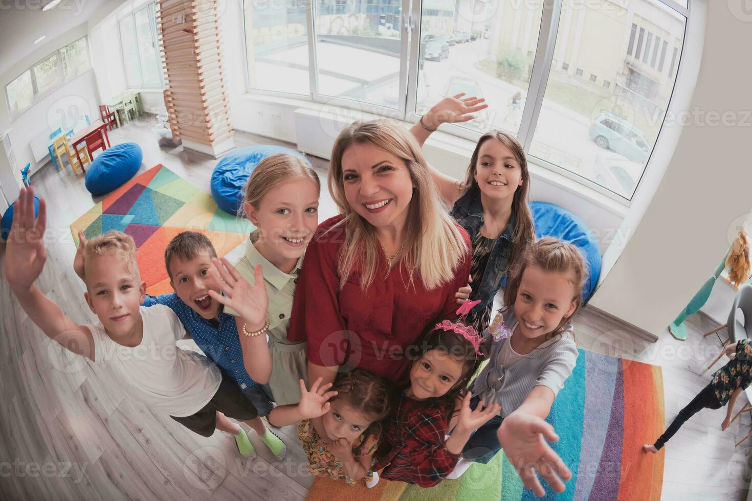 photo of children in a preschool institution standing in the classroom together with the teacher