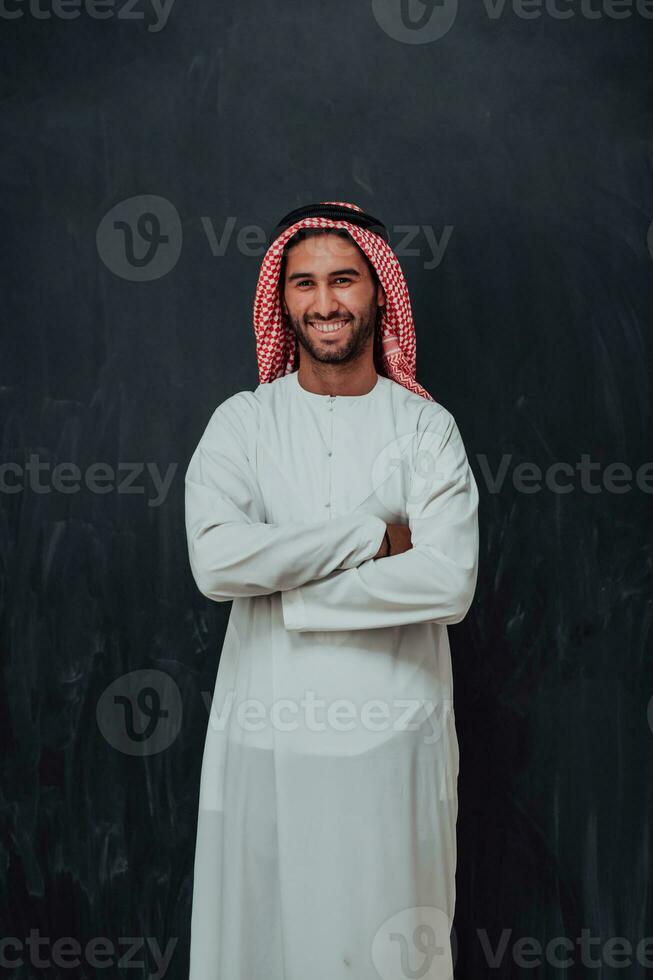 Portrait of young muslim man wearing traditional clothes photo