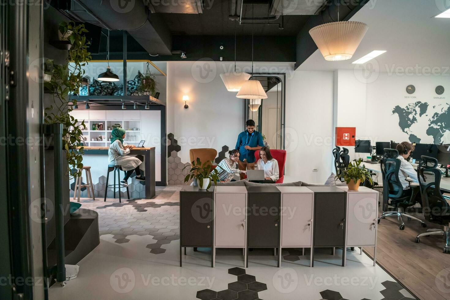 Group of casual multiethnic business people taking break from the work doing different things while enjoying free time in relaxation area at modern open plan startup office photo