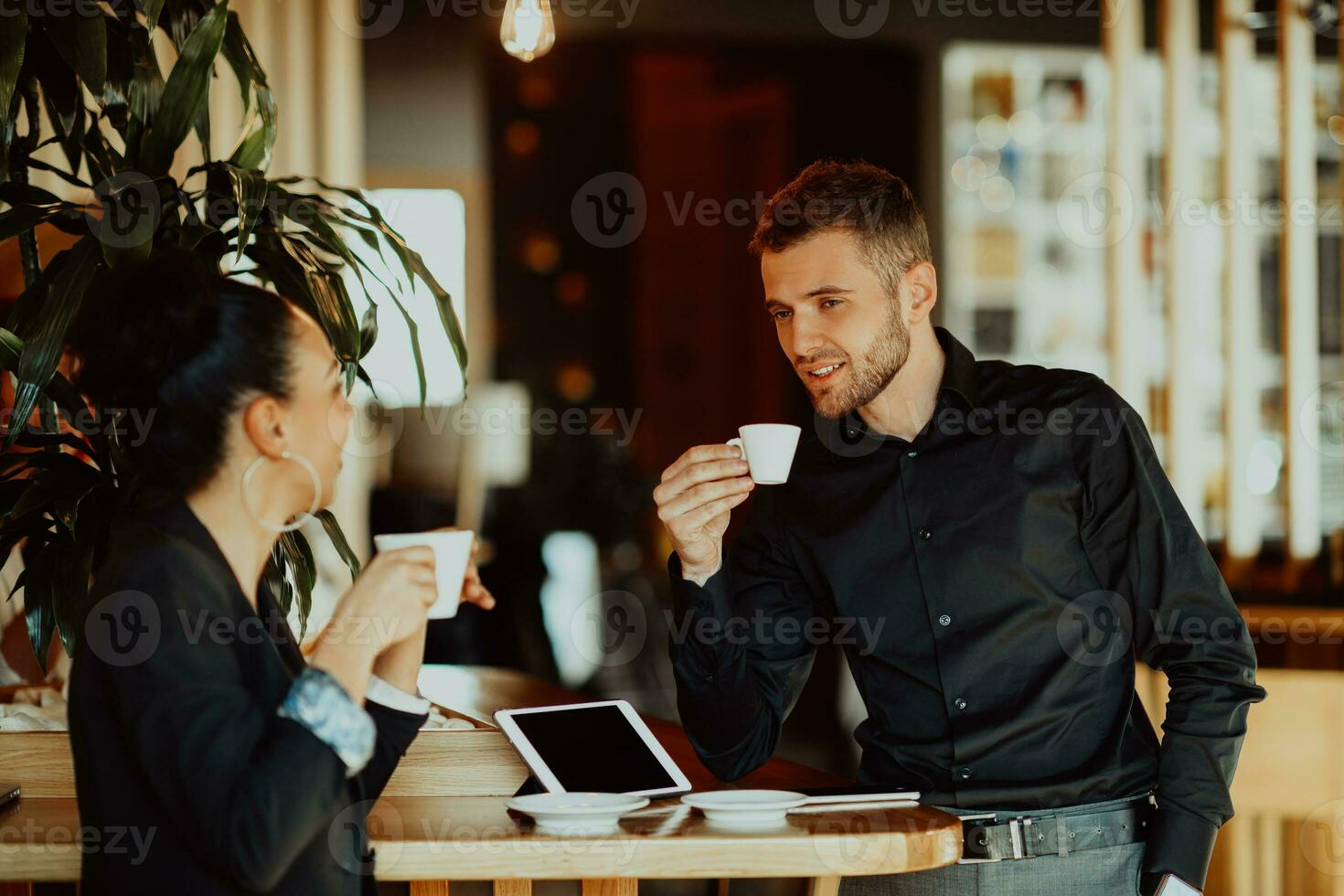 two young people on a break from work in a cafe take a break from everyday obligations. photo