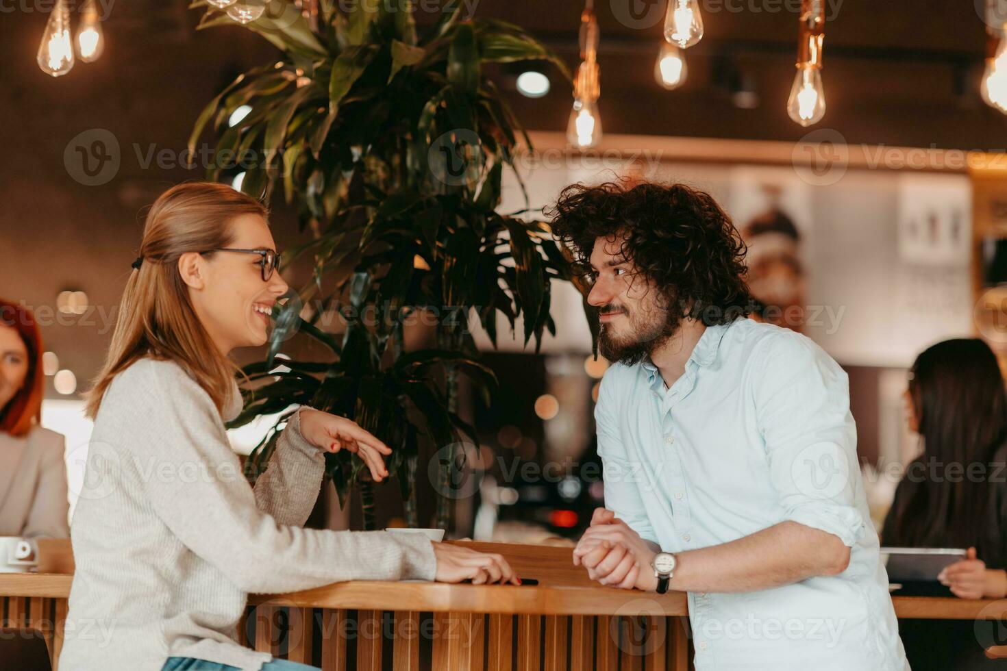 Business couple sits in a cafe after a weekday. photo