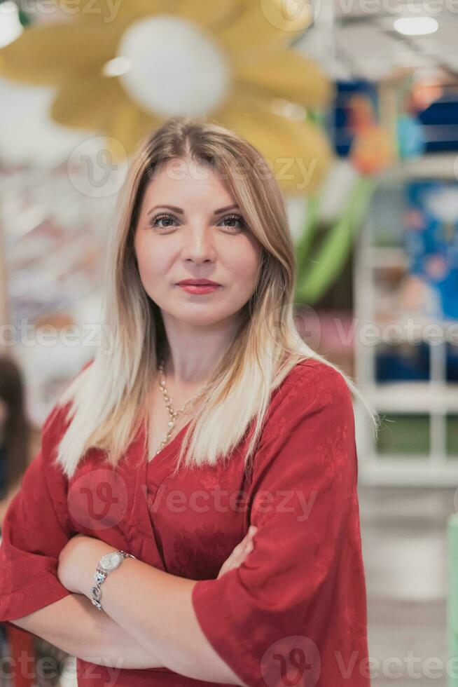 Portrait of a teacher in a preschool institution, in the background of the classrooms photo