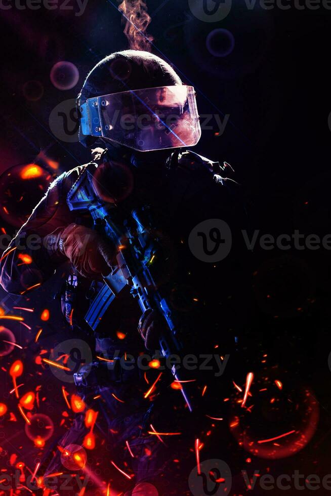 Army soldier in Combat Uniforms with an assault rifle and combat helmet night mission dark background. Blue and purple gel light effect. photo