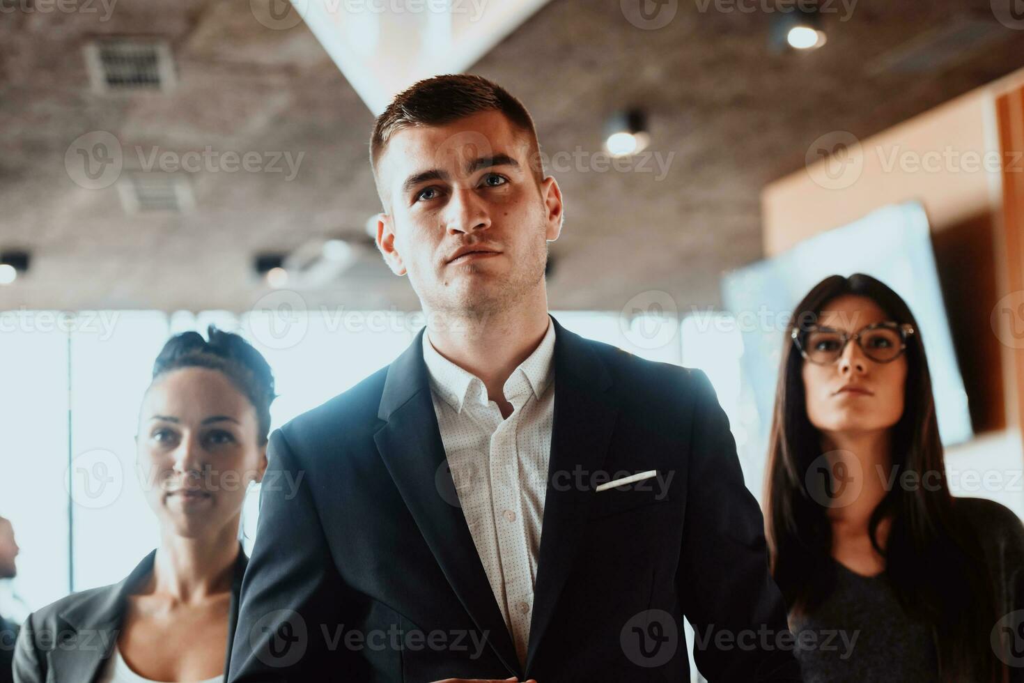 Group of successful business people standing together at modern coworking office. photo