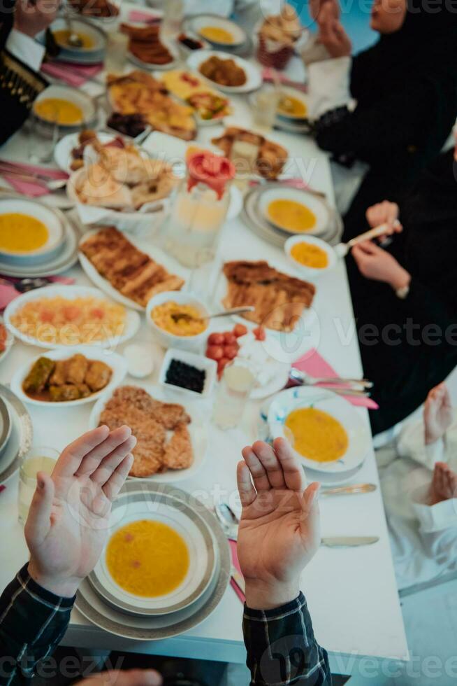 Top view of Muslim family having Iftar dinner drinking water to break feast. Eating traditional food during Ramadan feasting month at home. The Islamic Halal Eating and Drinking in modern home photo