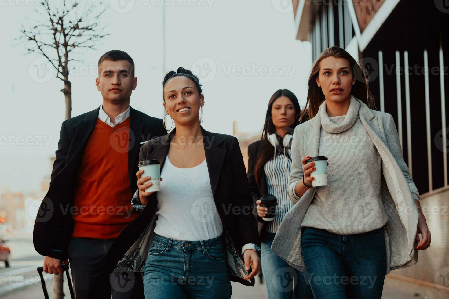 Business colleagues walking and talking on city streets photo