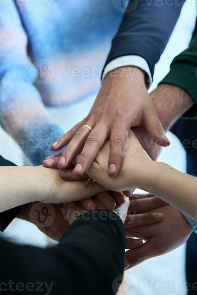 A top view photo of group of businessmen holding hands together to symbolize unity and strength