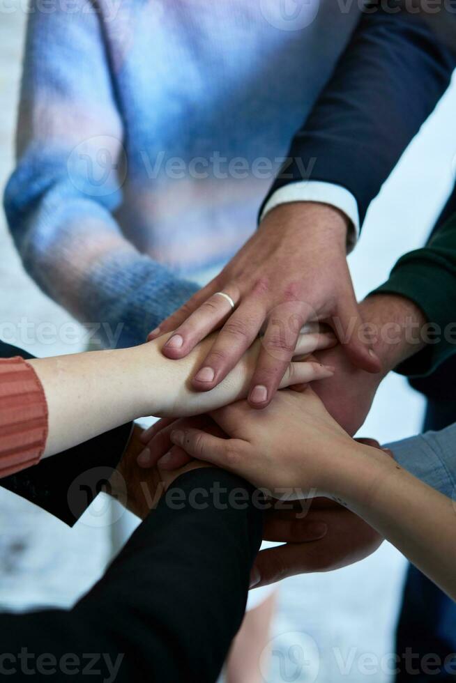 A top view photo of group of businessmen holding hands together to symbolize unity and strength