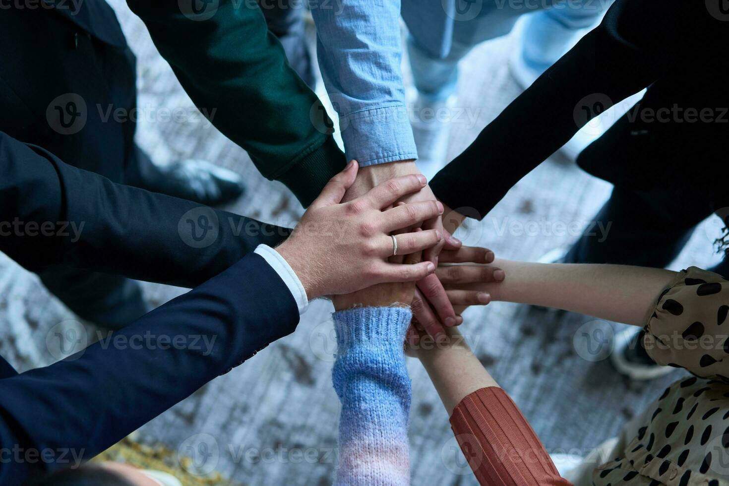 A top view photo of group of businessmen holding hands together to symbolize unity and strength