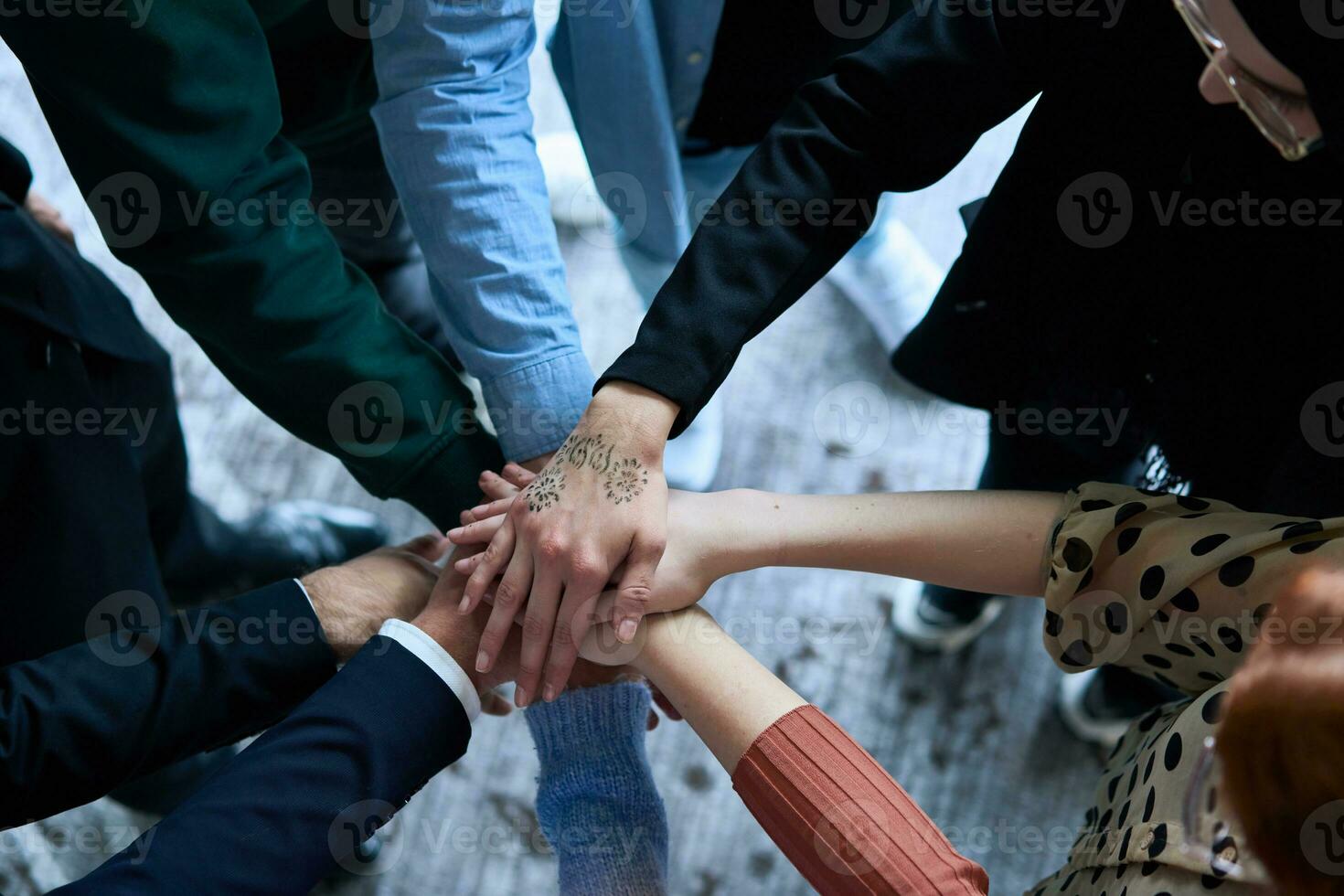 A top view photo of group of businessmen holding hands together to symbolize unity and strength