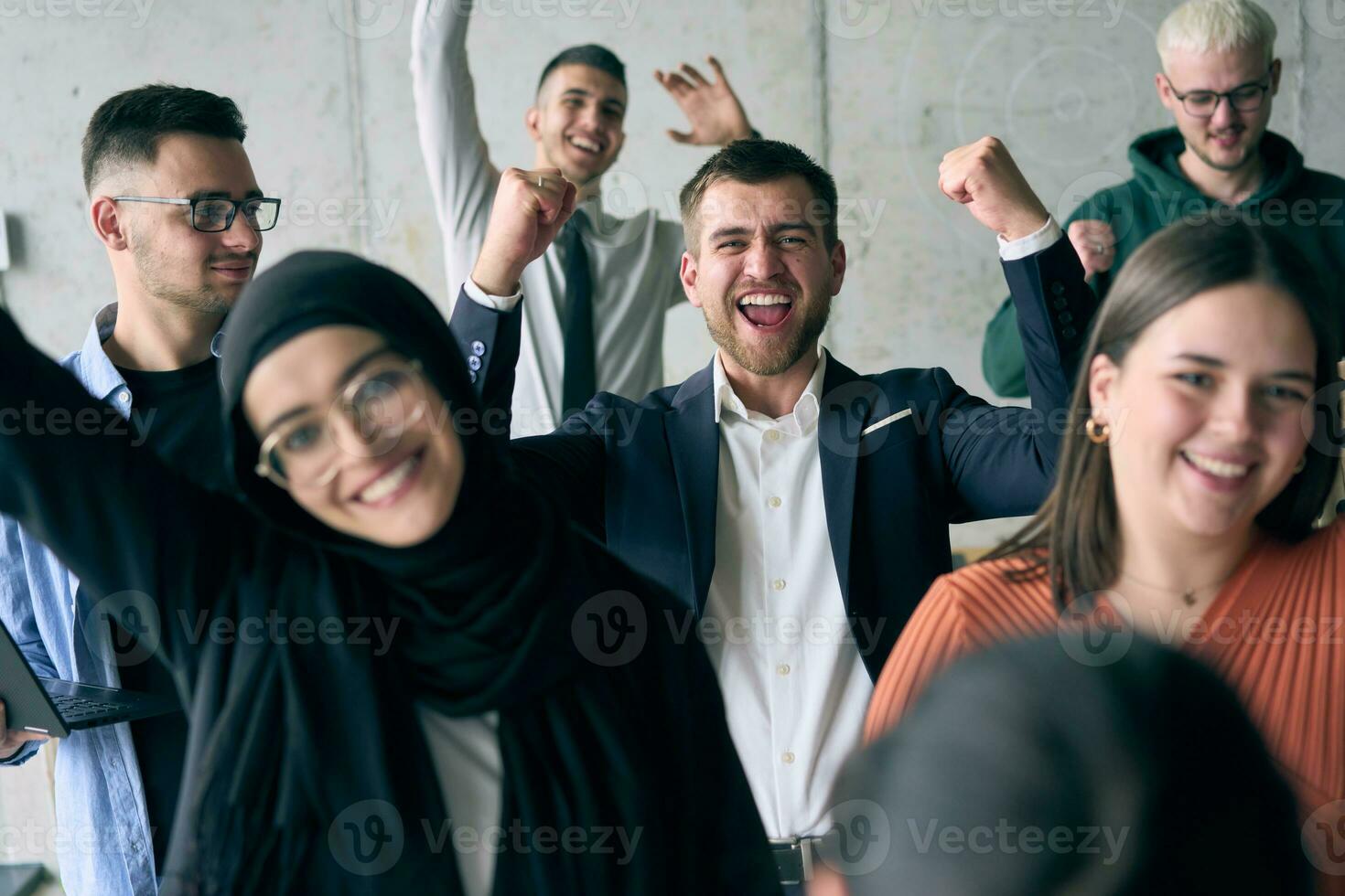 A diverse group of successful businessmen raises their hands in the air, symbolizing achievement, accomplishment, and the fulfillment of goals, exuding confidence, unity, and celebration of their collective success. photo