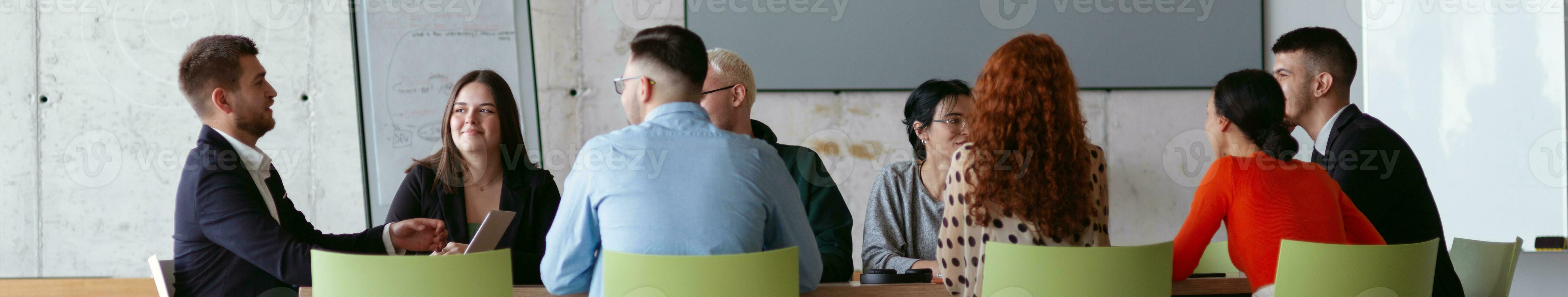 Wide crop photo of a diverse group of business professionals gathered at a modern office for a productive and inclusive meeting