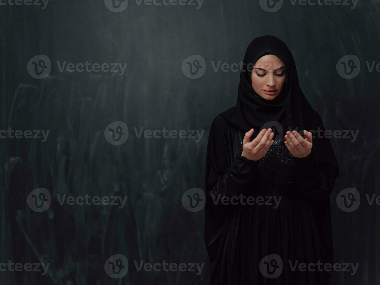 Portrait of young Muslim woman making dua photo