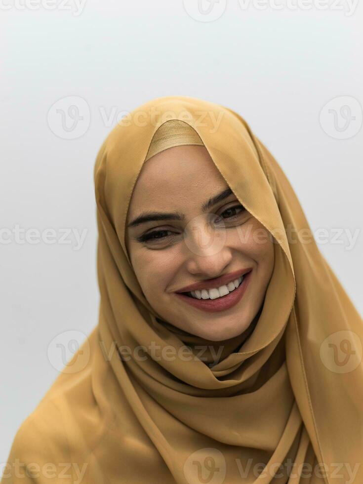 Portrait of young muslim woman wearing hijab on isolated white background photo