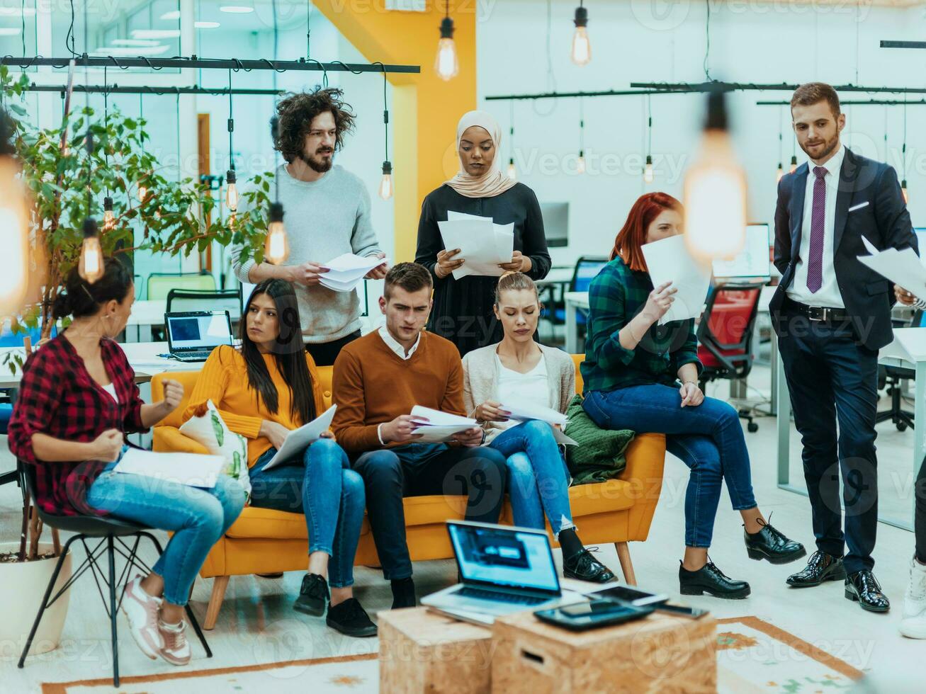 Multiethnic group of employees working in a marketing company. A group of colleagues is working on a project in modern offices photo