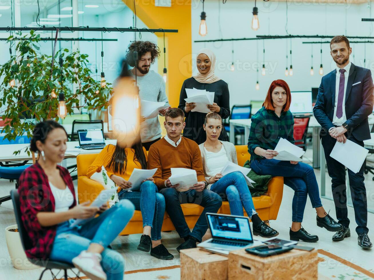 Multiethnic group of employees working in a marketing company. A group of colleagues is working on a project in modern offices photo