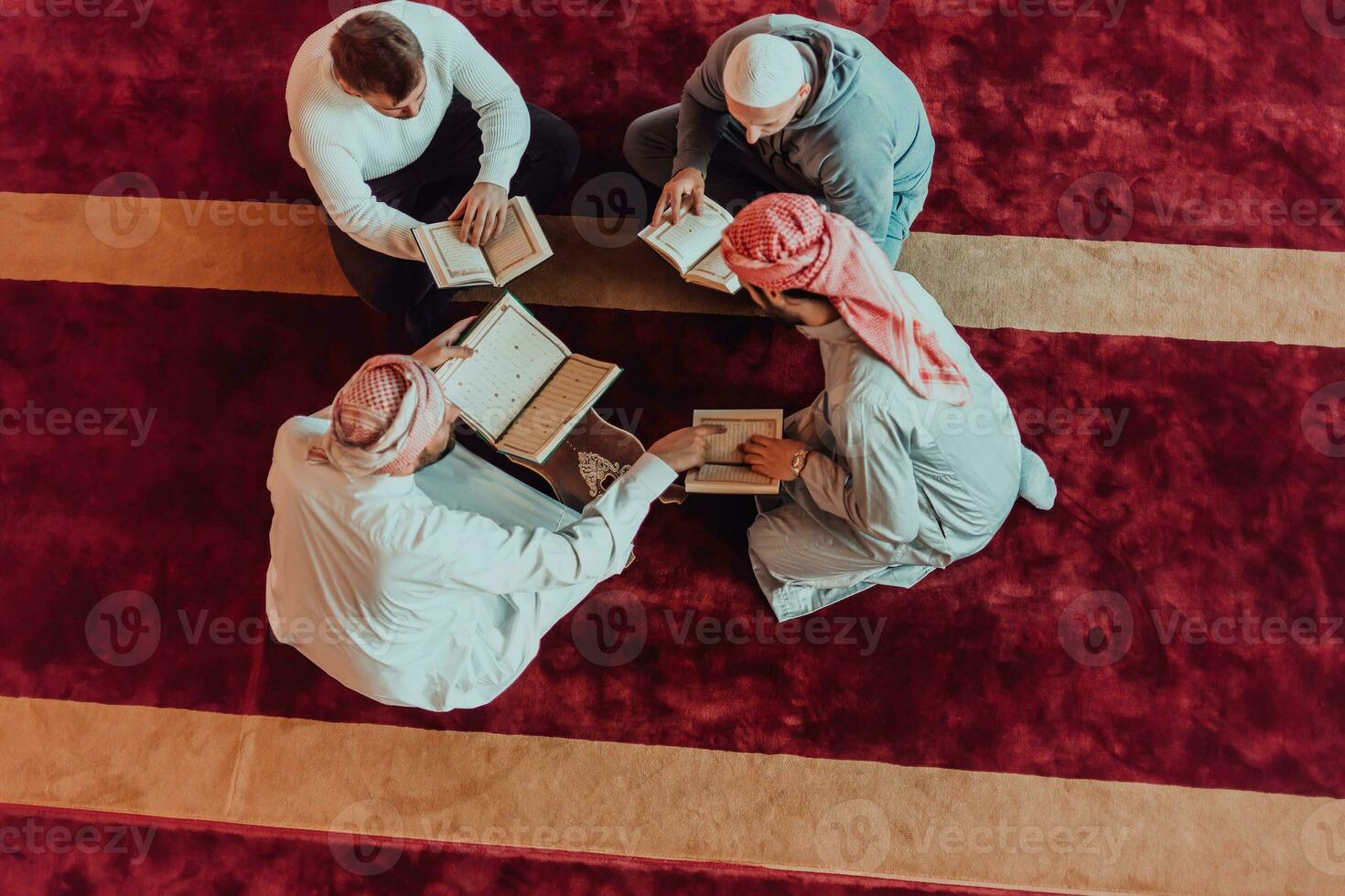 A group of Muslims reading the holy book of the Quran in a modern mosque during the Muslim holiday of Ramadan photo