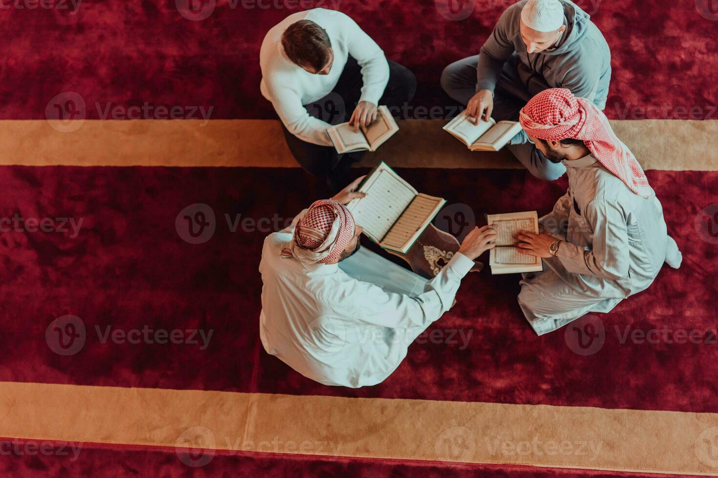 A group of Muslims reading the holy book of the Quran in a modern mosque during the Muslim holiday of Ramadan photo