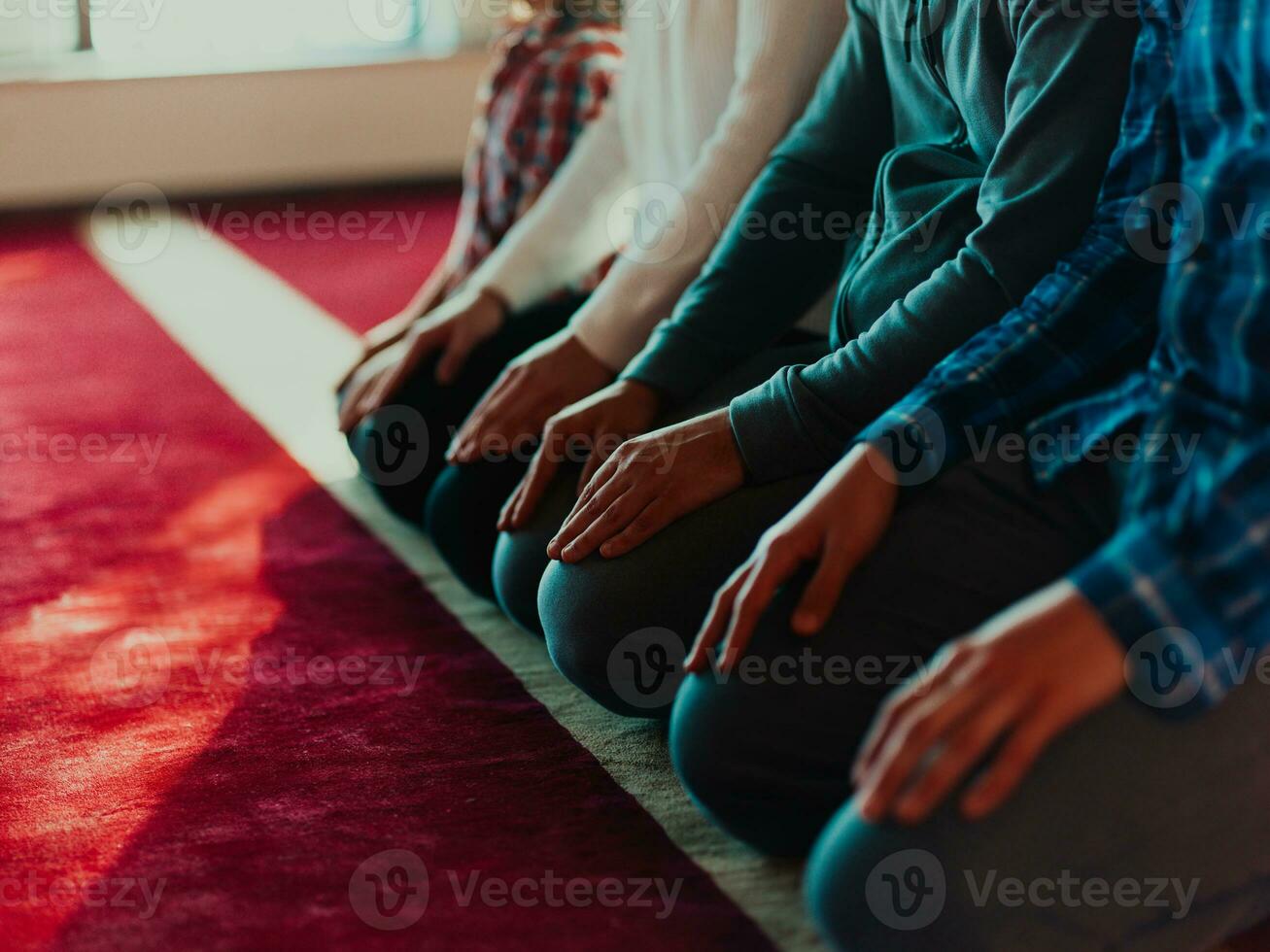 A group of Muslims in a modern mosque praying the Muslim prayer namaz, during the holy month of Ramadan photo