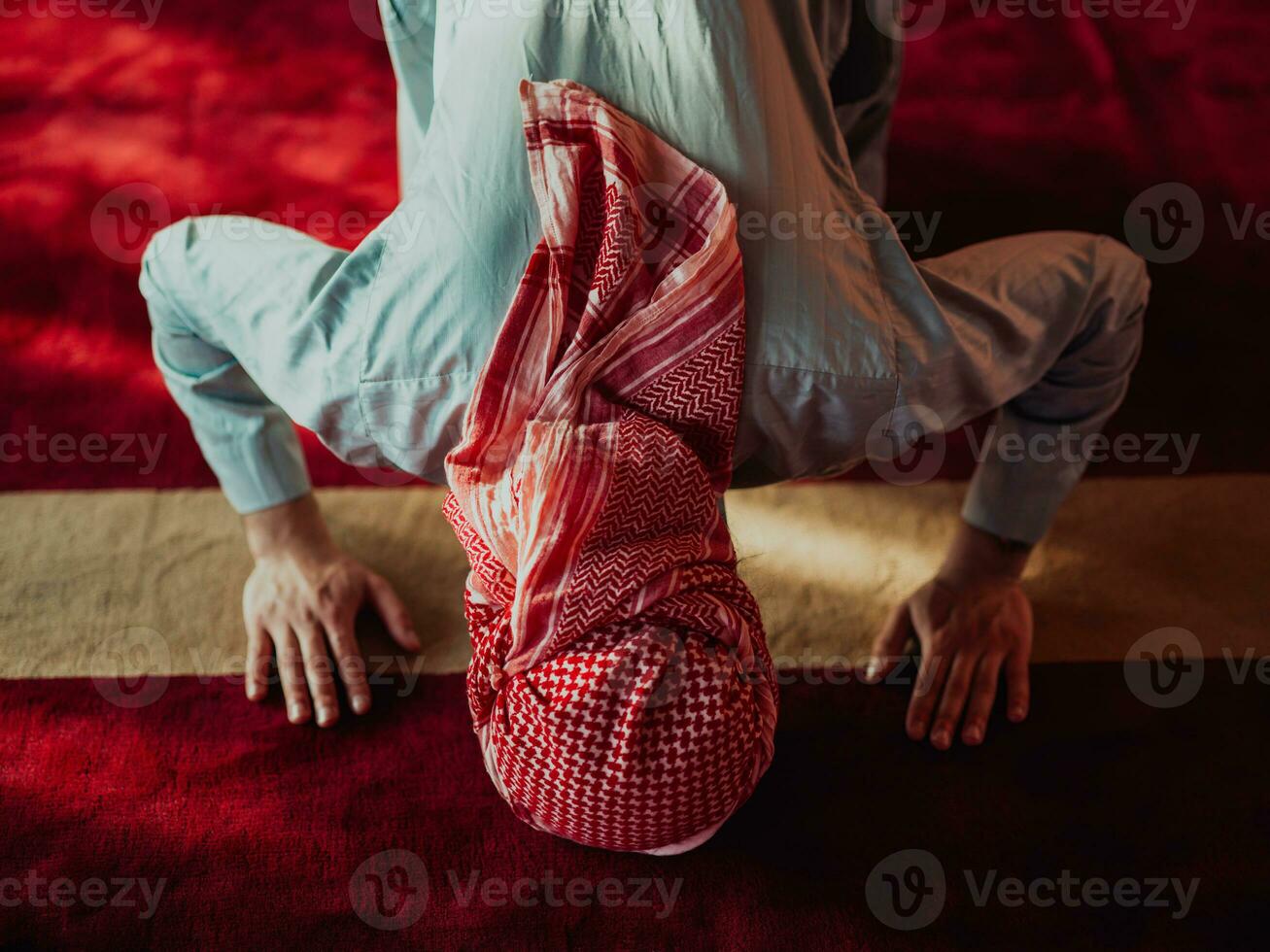A Muslim praying in a modern mosque during the holy Muslim month of Ramadan photo