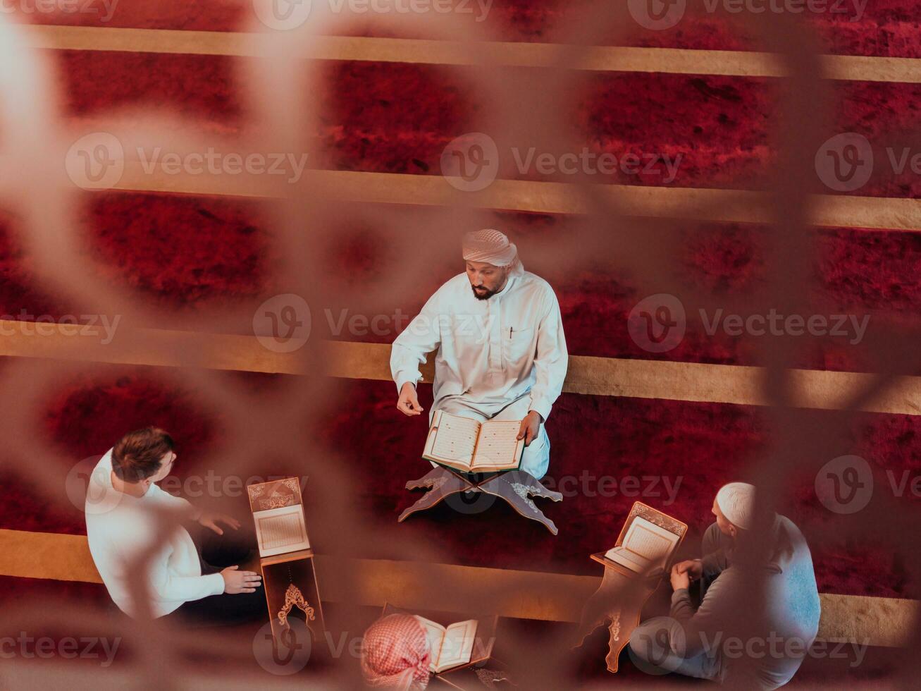 A group of Muslims reading the holy book of the Quran in a modern mosque during the Muslim holiday of Ramadan photo