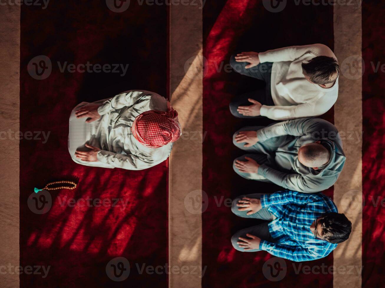 A group of Muslims in a modern mosque praying the Muslim prayer namaz, during the holy month of Ramadan photo