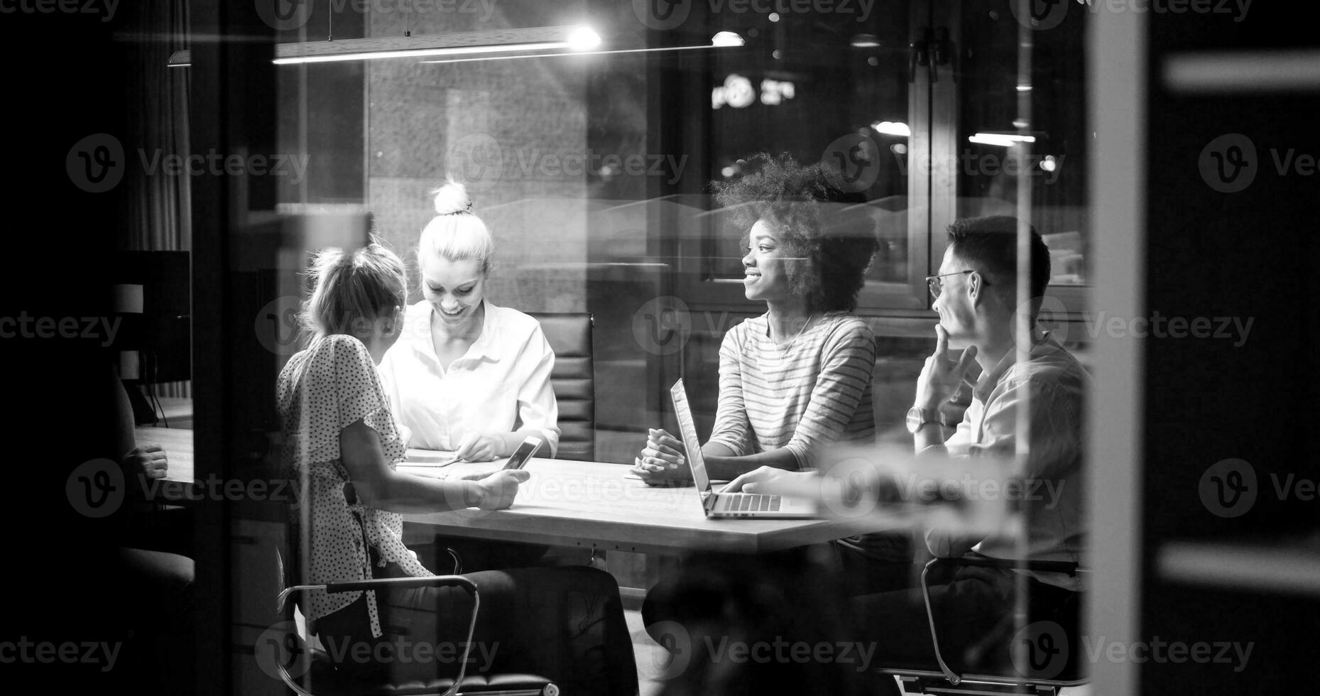 Multiethnic startup business team in night office photo