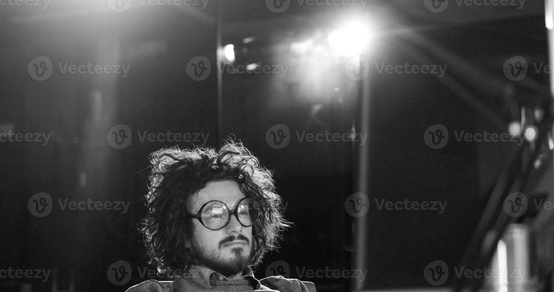 man working on computer in dark office photo