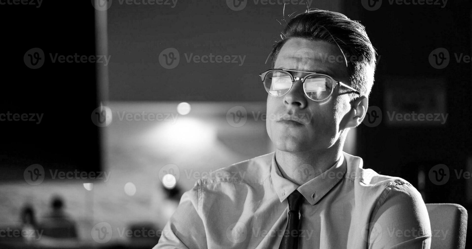 man working on computer in dark office photo