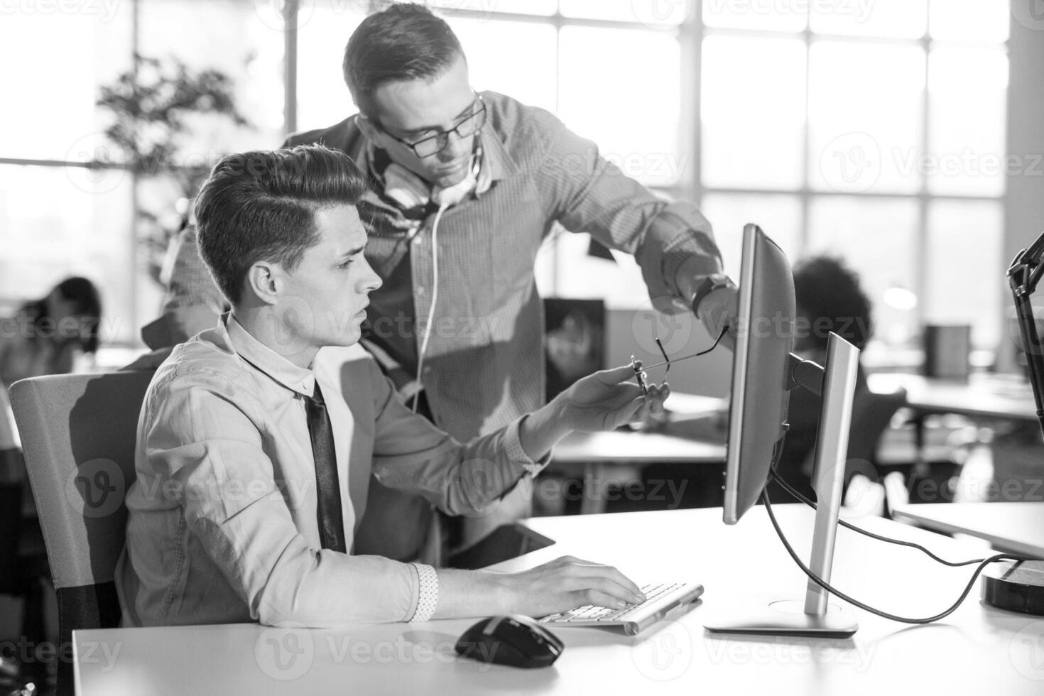 Two Business People Working With computer in office photo
