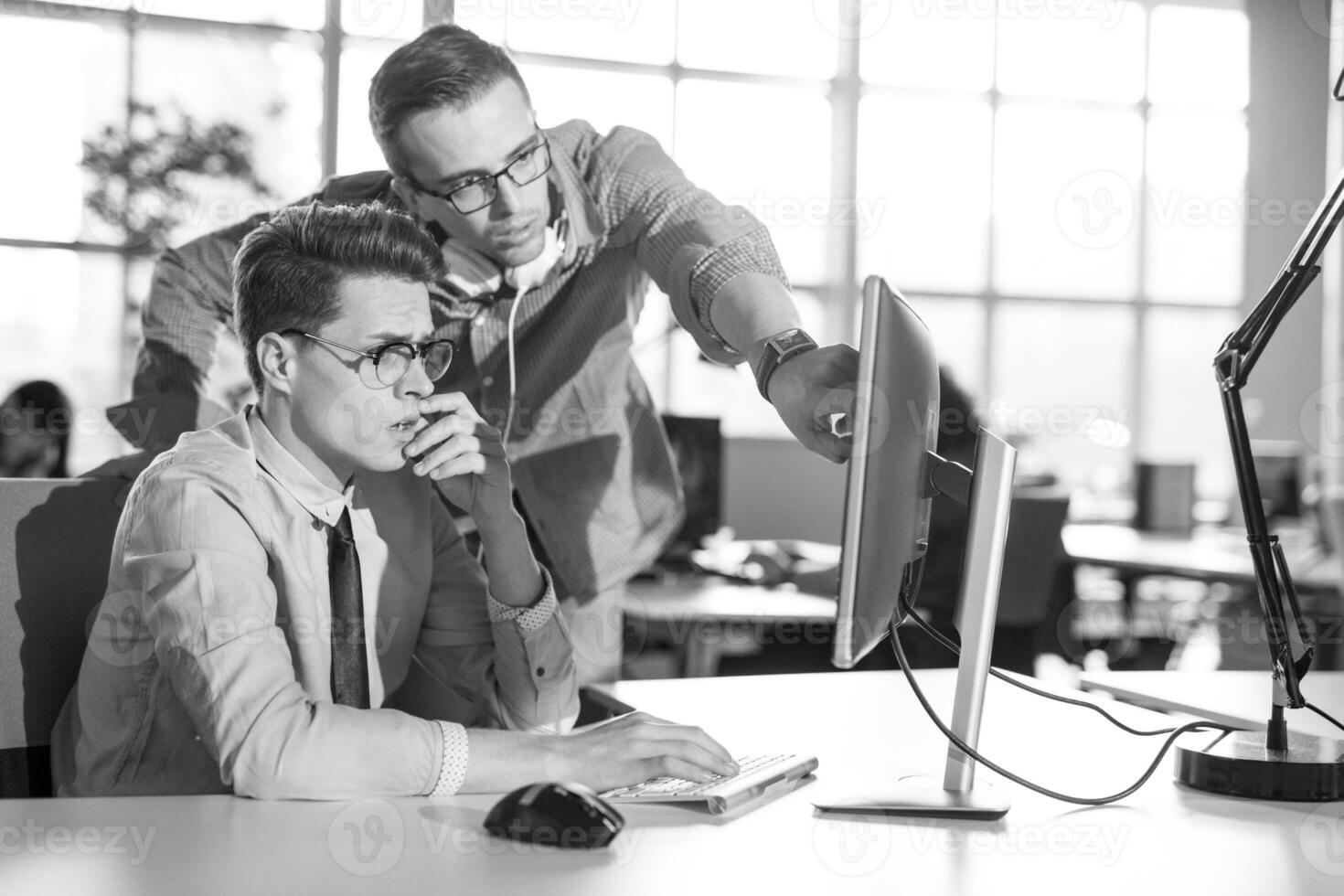 Two Business People Working With computer in office photo