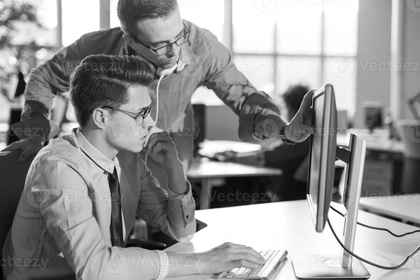 Two Business People Working With computer in office photo
