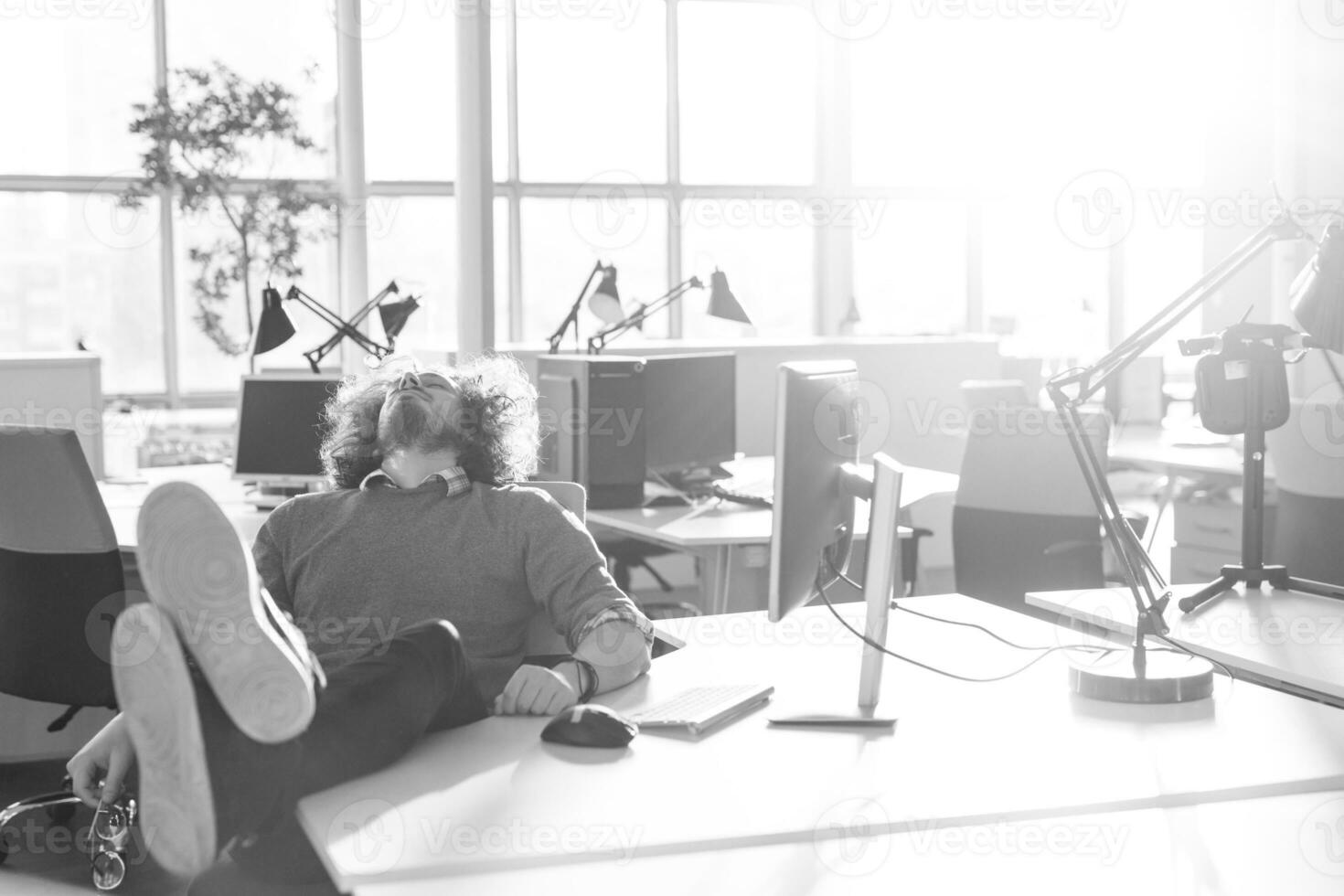businessman sitting with legs on desk photo