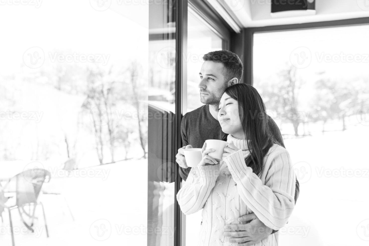 multiethnic couple enjoying morning coffee by the window photo