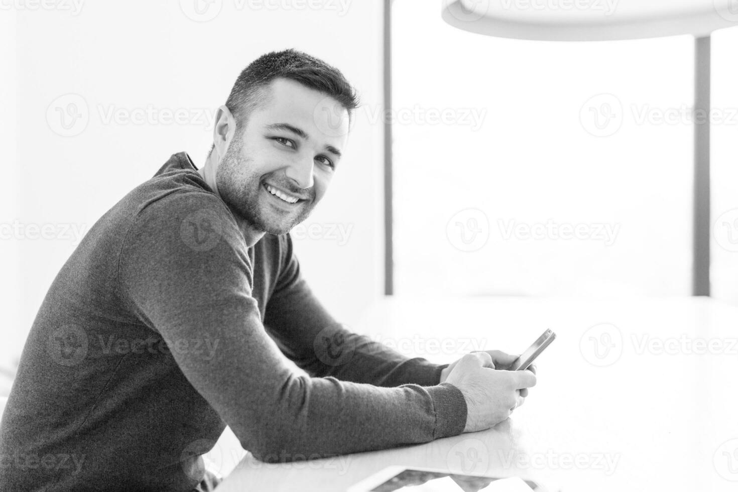 Young casual businessman using smartphone photo
