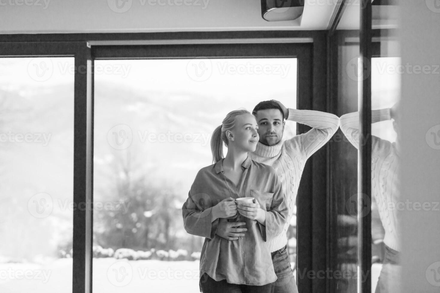 young couple enjoying evening tea by the window photo