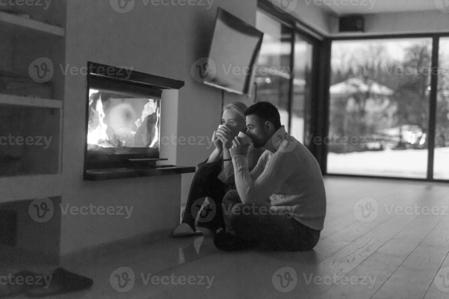 happy couple in front of fireplace photo