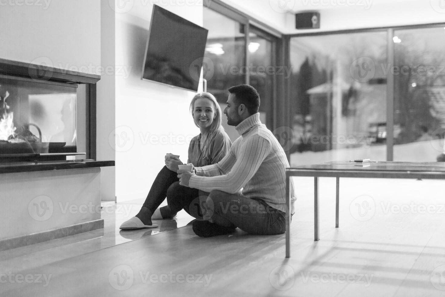 happy couple in front of fireplace photo