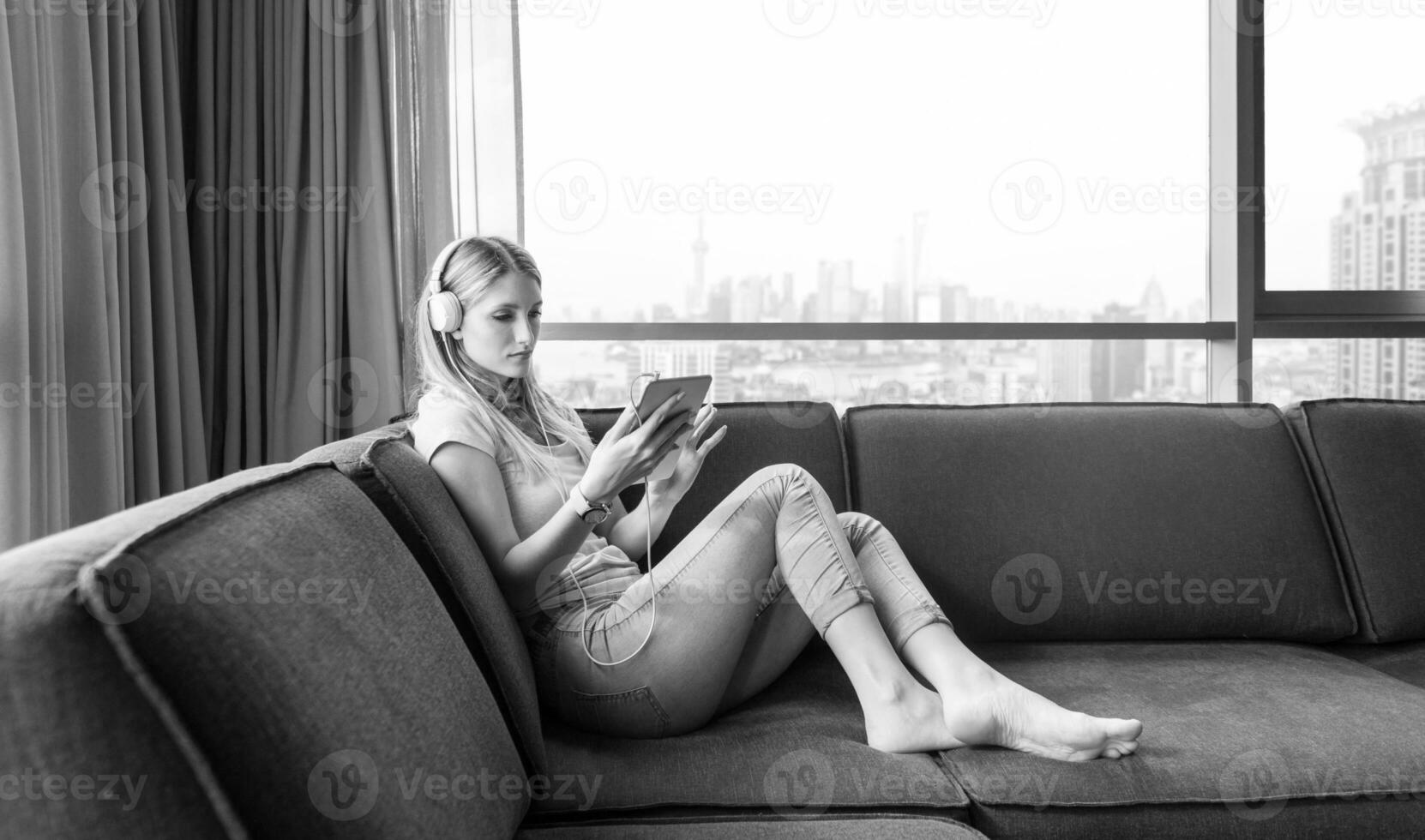 young girl enjoying music through headphones photo