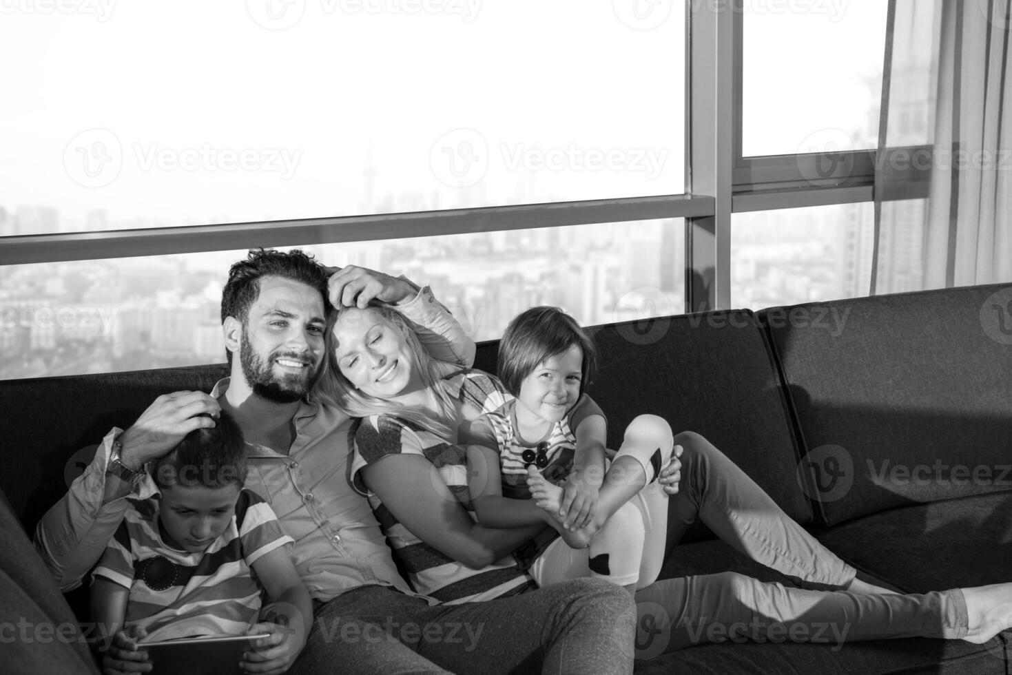 happy young couple spending time with kids at home photo